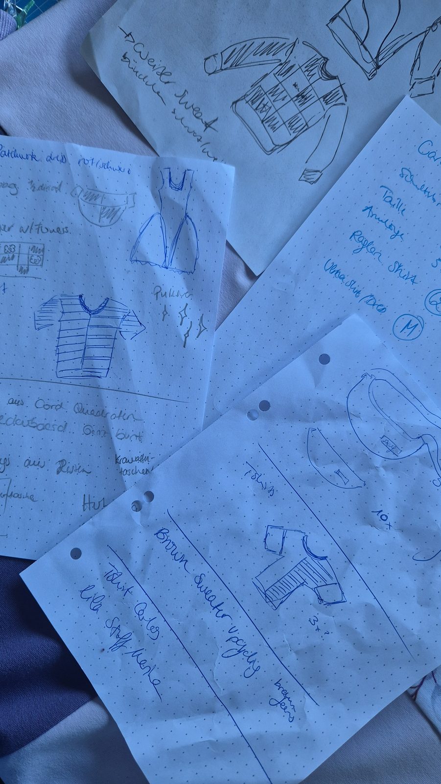 Handgezeichnete Skizzen und Notizen auf blauem Papier